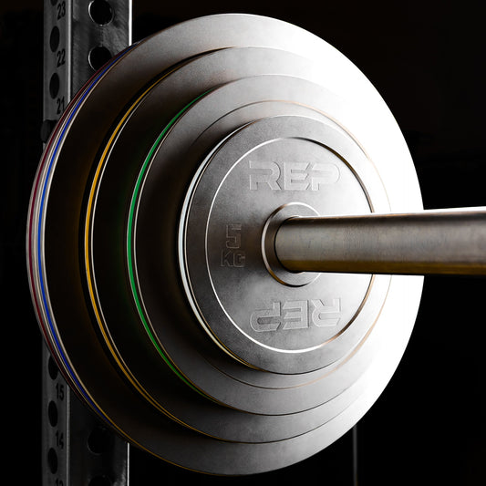 REP Fitness Calibrated Steel Plates in KG loaded onto a barbell on a PR-5000 rack